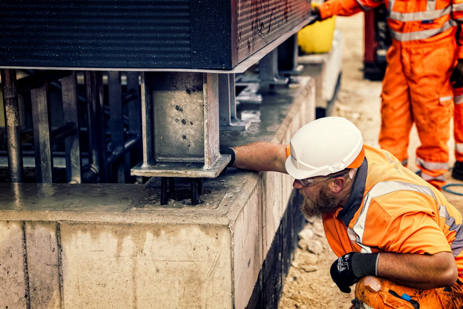 Close detail of a worker checking a structural fixing point